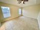 Bright bedroom with tile floors and ceiling fan at 61 Fir Dr, Ocala, FL 34472
