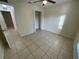 Bedroom with tile floors and access to another room at 61 Fir Dr, Ocala, FL 34472