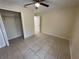 Bedroom with tile floors, closet, and access to bathroom at 61 Fir Dr, Ocala, FL 34472