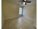 Spacious bedroom with tile floors and large window at 61 Fir Dr, Ocala, FL 34472