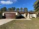 House exterior featuring a brown garage door and walkway at 61 Fir Dr, Ocala, FL 34472