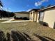 Side view of a house showcasing a walkway and landscaping at 61 Fir Dr, Ocala, FL 34472