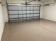 Spacious garage with epoxy flooring and open garage door at 61 Fir Dr, Ocala, FL 34472
