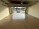 Garage with epoxy flooring and view of driveway at 61 Fir Dr, Ocala, FL 34472