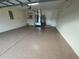 Garage with epoxy flooring, storage, and AC unit at 61 Fir Dr, Ocala, FL 34472