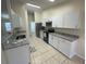 Modern kitchen with white cabinets and granite countertops at 61 Fir Dr, Ocala, FL 34472