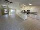 Open concept kitchen with white cabinets and granite counters at 61 Fir Dr, Ocala, FL 34472