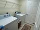 Bright laundry room with washer, dryer, and ample shelving at 61 Fir Dr, Ocala, FL 34472