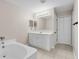 Bathroom boasts a double vanity and a relaxing bathtub at 632 Monte Vista Way, Winter Garden, FL 34787