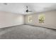 Large bedroom with ceiling fan, neutral carpeting, and two windows at 632 Monte Vista Way, Winter Garden, FL 34787