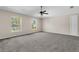Spacious bedroom with ceiling fan, neutral carpeting, and two windows at 632 Monte Vista Way, Winter Garden, FL 34787