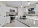 Updated kitchen boasts white cabinets, granite countertops and stainless steel appliances at 632 Monte Vista Way, Winter Garden, FL 34787