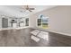 Living room with wood-look floors, ceiling fan and kitchen view at 632 Monte Vista Way, Winter Garden, FL 34787