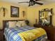 Cozy bedroom featuring a comfortable bed, dresser, and warm yellow walls at 752 Maybank Loop, The Villages, FL 32162