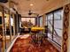 Enclosed sunroom with comfortable seating and access to additional patio space at 752 Maybank Loop, The Villages, FL 32162