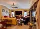 Comfortable living room with a large-screen TV, fireplace, and access to the lanai at 752 Maybank Loop, The Villages, FL 32162