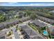 Aerial view of townhouses with community pool and lush landscaping at 765 Walkers Grove Ln, Winter Garden, FL 34787