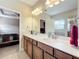 Double vanity bathroom with a view into the bedroom at 765 Walkers Grove Ln, Winter Garden, FL 34787