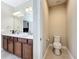 Double vanity bathroom with separate toilet and linen closet at 765 Walkers Grove Ln, Winter Garden, FL 34787