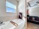 Relaxing bathroom featuring a soaking tub and a view of the bedroom at 765 Walkers Grove Ln, Winter Garden, FL 34787