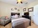 Bedroom with a queen bed, armchair and TV at 765 Walkers Grove Ln, Winter Garden, FL 34787