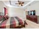 Spacious bedroom with king-size bed, dresser, and ceiling fan at 765 Walkers Grove Ln, Winter Garden, FL 34787