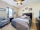 Bedroom with queen bed, armchair, and window at 765 Walkers Grove Ln, Winter Garden, FL 34787