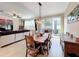 Spacious dining area with a large wooden table, adjacent to the living room at 765 Walkers Grove Ln, Winter Garden, FL 34787