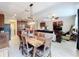 Open concept dining room with wooden table, overlooking kitchen and living room at 765 Walkers Grove Ln, Winter Garden, FL 34787