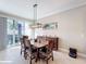 Bright dining room featuring a wood table and access to a patio at 765 Walkers Grove Ln, Winter Garden, FL 34787