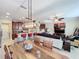 Open concept dining room with a large wooden table and kitchen views at 765 Walkers Grove Ln, Winter Garden, FL 34787