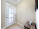 Side entry with tiled floor, white door and a small table at 765 Walkers Grove Ln, Winter Garden, FL 34787