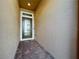 Front entry with brick flooring and modern dark brown door at 765 Walkers Grove Ln, Winter Garden, FL 34787