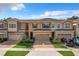 Two-story townhome with two-car garage and landscaped front yard at 765 Walkers Grove Ln, Winter Garden, FL 34787