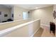 Upper hallway with neutral walls and carpet, leading to bedrooms at 765 Walkers Grove Ln, Winter Garden, FL 34787