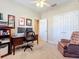 Home office with desk, bookshelves and comfortable chair at 765 Walkers Grove Ln, Winter Garden, FL 34787