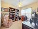 Home office with built-in bookshelves and a work desk at 765 Walkers Grove Ln, Winter Garden, FL 34787