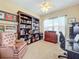 Spacious home office with large desk and bookshelves at 765 Walkers Grove Ln, Winter Garden, FL 34787
