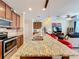 Open kitchen with island, granite counters & stainless steel appliances at 765 Walkers Grove Ln, Winter Garden, FL 34787