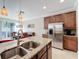 Granite kitchen island with double sink and breakfast bar at 765 Walkers Grove Ln, Winter Garden, FL 34787