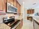 Kitchen with stainless steel appliances and granite countertops at 765 Walkers Grove Ln, Winter Garden, FL 34787