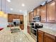 Kitchen with stainless steel appliances and granite countertops at 765 Walkers Grove Ln, Winter Garden, FL 34787