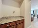 Bright laundry room with granite countertop and cabinets at 765 Walkers Grove Ln, Winter Garden, FL 34787