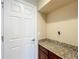 Laundry room with granite countertop and built-in cabinets at 765 Walkers Grove Ln, Winter Garden, FL 34787