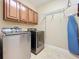 Convenient laundry room with washer, dryer, and ample storage at 765 Walkers Grove Ln, Winter Garden, FL 34787
