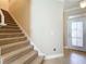 Beige carpeted staircase with simple design at 765 Walkers Grove Ln, Winter Garden, FL 34787