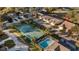 Aerial view showing the property's location near a tennis court and pool at 8801 Village Green Blvd, Clermont, FL 34711