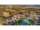 Aerial view showcasing the home's location in a community with tennis courts and a pool at 8801 Village Green Blvd, Clermont, FL 34711
