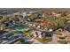 Home's location highlighted in an aerial view of a community with a tennis court and pool at 8801 Village Green Blvd, Clermont, FL 34711