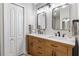 Modern bathroom with double vanity, wood cabinets, and black accents at 8801 Village Green Blvd, Clermont, FL 34711